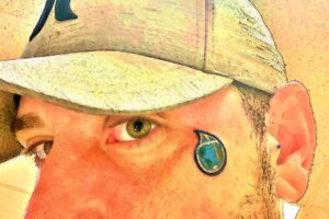 face of corey lee sargent dba green miyagi with earth teardrop brand logo face tattoo